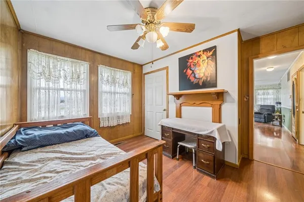 a bedroom with a bed dresser and a window