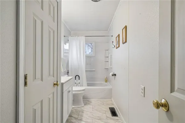 a bathroom with a shower a toilet and a shower