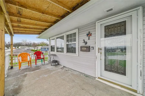 a view of a room with wooden floor and windows