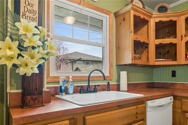 a kitchen with a sink and a mirror