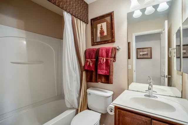 a view of a house with a yard and hanging chair