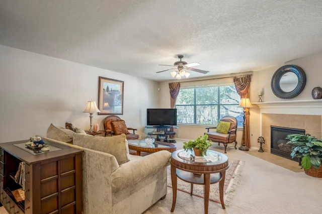 a living room with furniture a fireplace and a flat screen tv