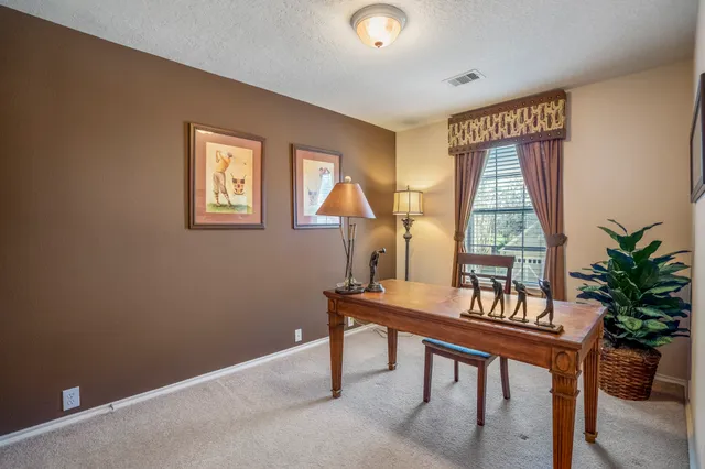 a dining room with table and chairs