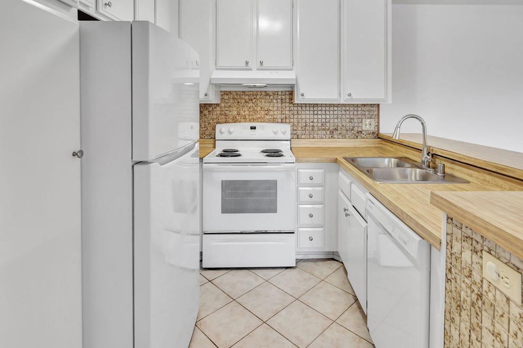 3571 Ruffin Road, Unit 239 San Diego, CA 92123 - Photo 11 of 33 a kitchen with a stove sink and cabinets