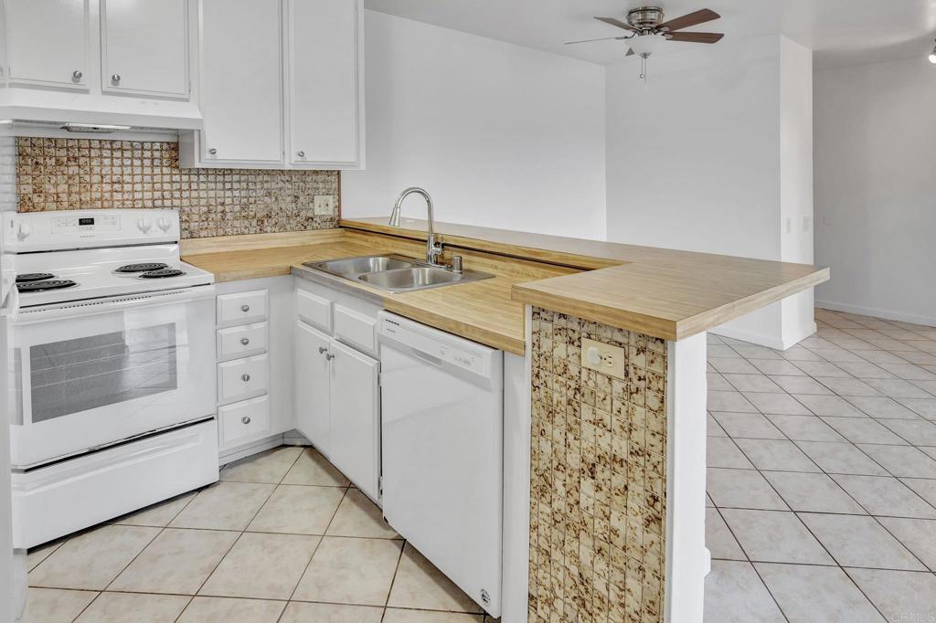 3571 Ruffin Road, Unit 239 San Diego, CA 92123 - Photo 12 of 33 a kitchen with a stove a sink and a microwave