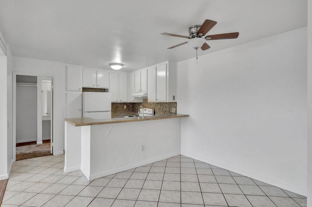3571 Ruffin Road, Unit 239 San Diego, CA 92123 - Photo 14 of 33 a kitchen with kitchen island a sink cabinets and stainless steel appliances