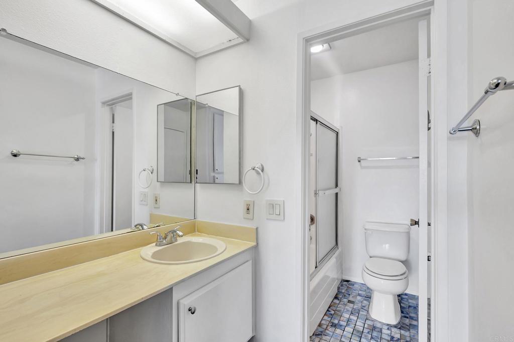 3571 Ruffin Road, Unit 239 San Diego, CA 92123 - Photo 25 of 33 a bathroom with a granite countertop sink toilet and shower
