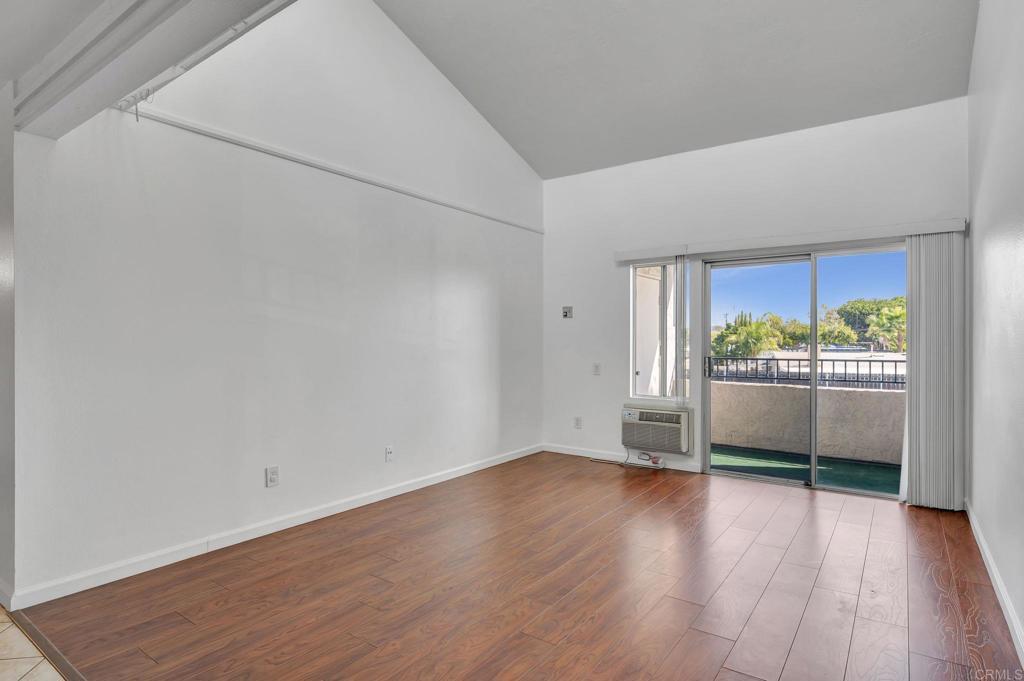 3571 Ruffin Road, Unit 239 San Diego, CA 92123 - Photo 6 of 33 a view of an empty room with wooden floor and a window