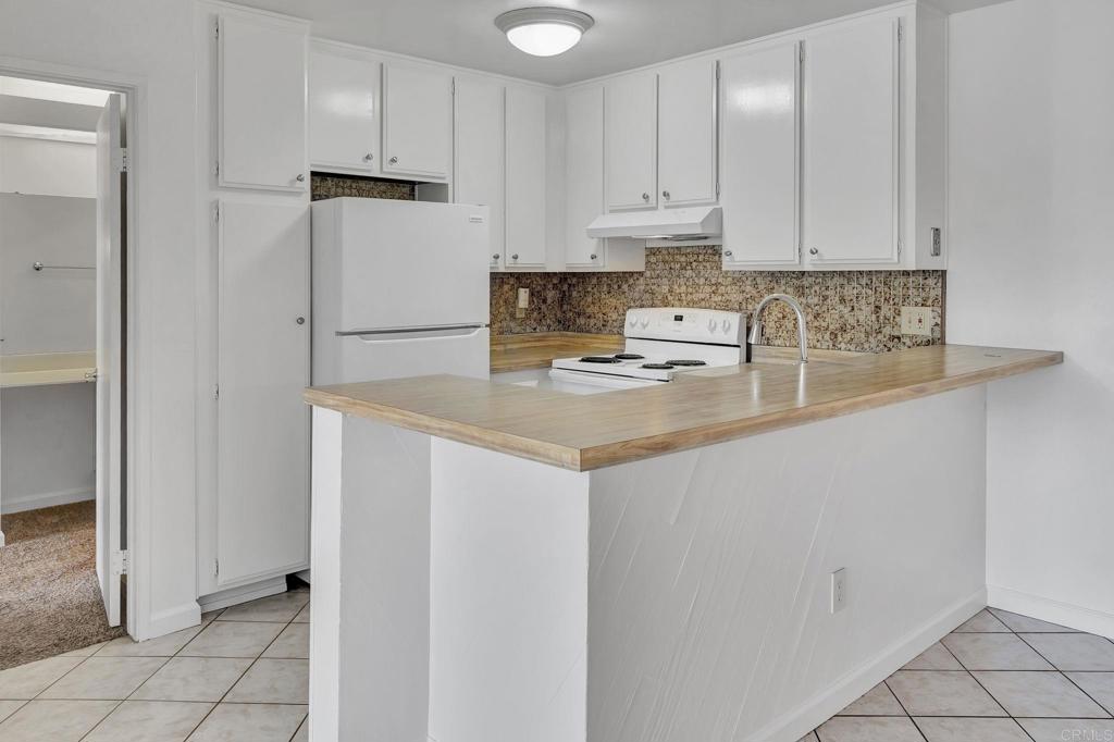 3571 Ruffin Road, Unit 239 San Diego, CA 92123 - Photo 9 of 33 a kitchen with stainless steel appliances granite countertop a refrigerator sink and white cabinets