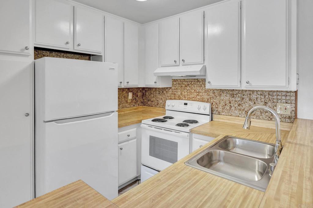 3571 Ruffin Road, Unit 239 San Diego, CA 92123 - Photo 10 of 33 a kitchen with a refrigerator sink stove and cabinets