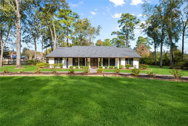 a front view of a house with yard and green space