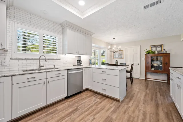 a kitchen with sink cabinets and wooden floor