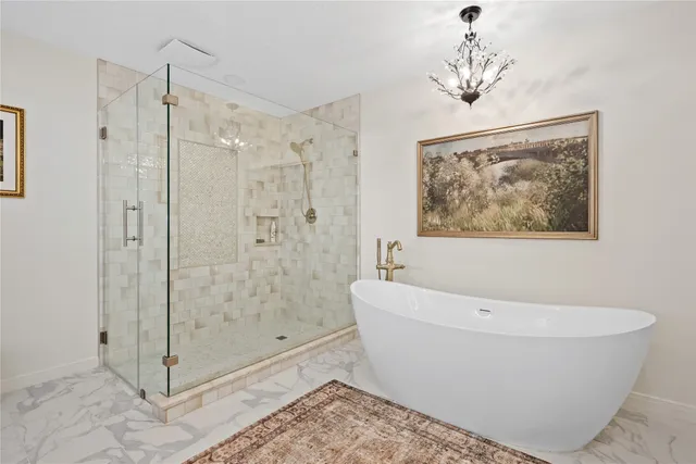 a white bath tub sitting next to a bathroom sink