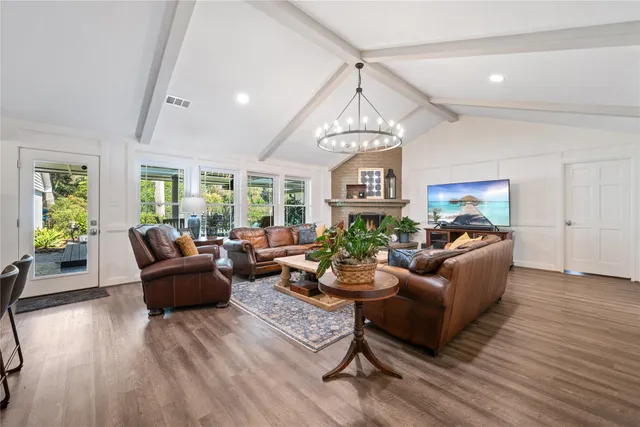a living room with furniture and a chandelier