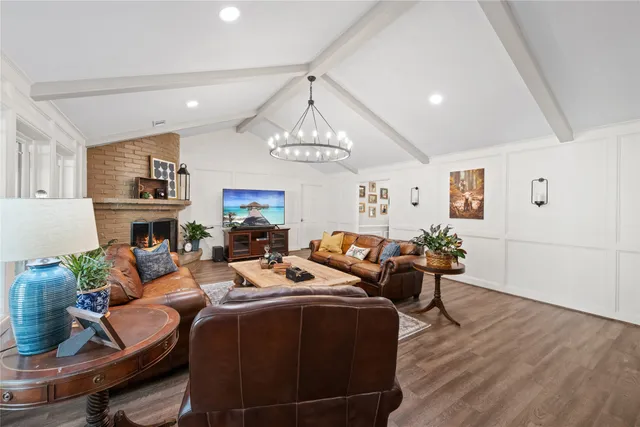 a living room with fireplace furniture and a chandelier