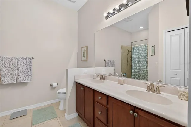 a bathroom with a toilet a sink and shower