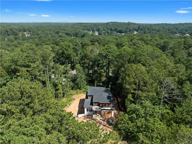 an aerial view of a house with a yard