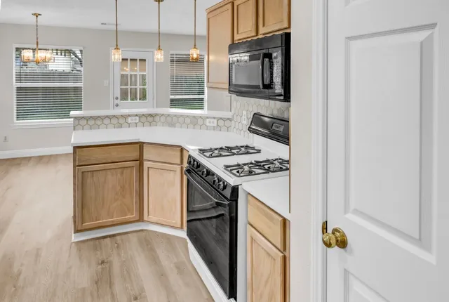 a kitchen with stainless steel appliances granite countertop a stove and a microwave