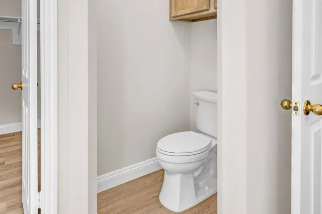 a bathroom with a toilet and a mirror