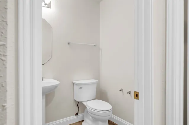 a white toilet sitting next to a white cabinet