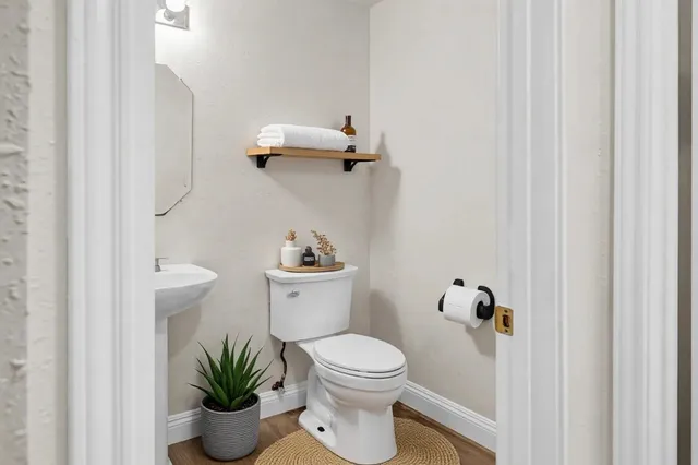 a white toilet sitting next to a bathroom sink