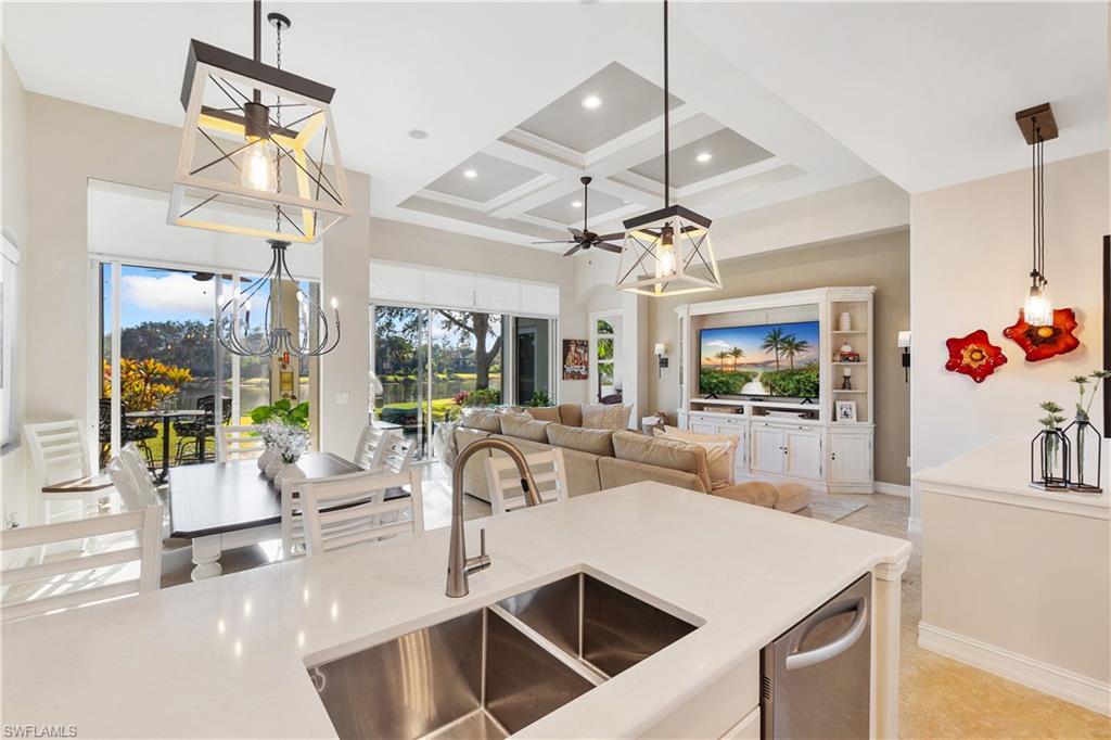 12612 Grandezza Circle Estero, FL 33928 - Photo 13 of 48 Kitchen featuring sink, hanging light fixtures, plenty of natural light, a high ceiling, and coffered ceiling