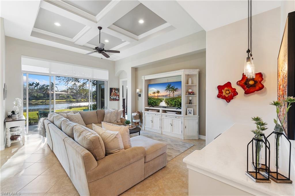 12612 Grandezza Circle Estero, FL 33928 - Photo 14 of 48 Living room featuring a towering ceiling, coffered ceiling, light tile patterned floors, ceiling fan, and beam ceiling