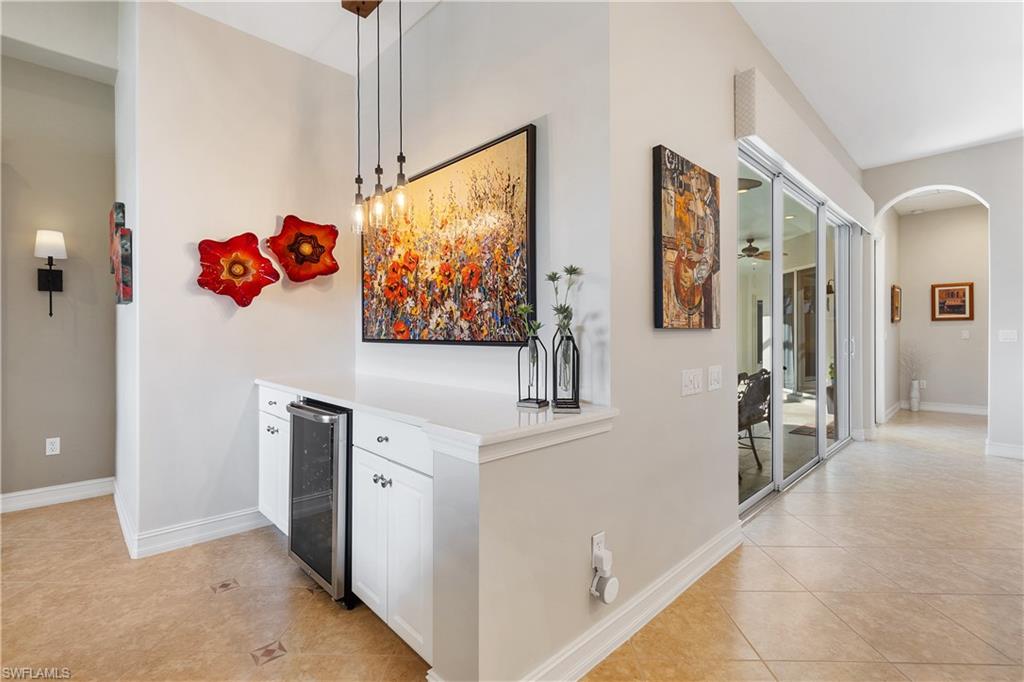 12612 Grandezza Circle Estero, FL 33928 - Photo 15 of 48 Corridor with wine cooler and light tile patterned floors
