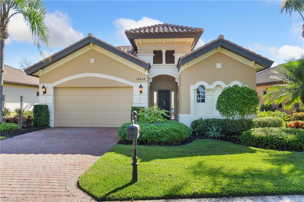 12612 Grandezza Circle Estero, FL 33928 - Photo 3 of 48 Mediterranean / spanish-style home with a garage and a front yard