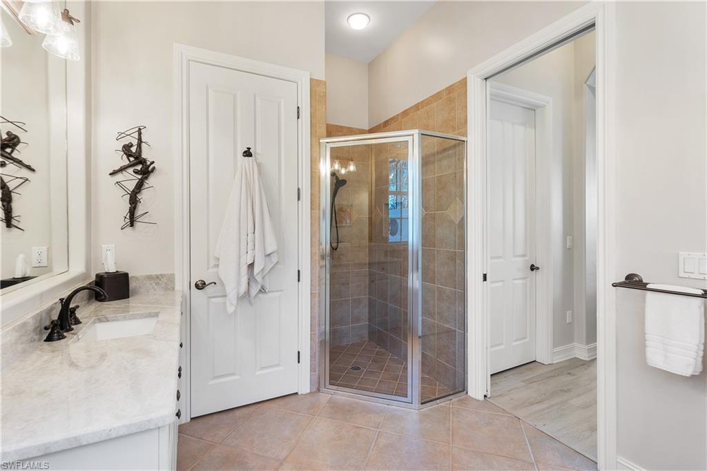 12612 Grandezza Circle Estero, FL 33928 - Photo 31 of 48 Bathroom featuring walk in shower, vanity, and tile patterned flooring