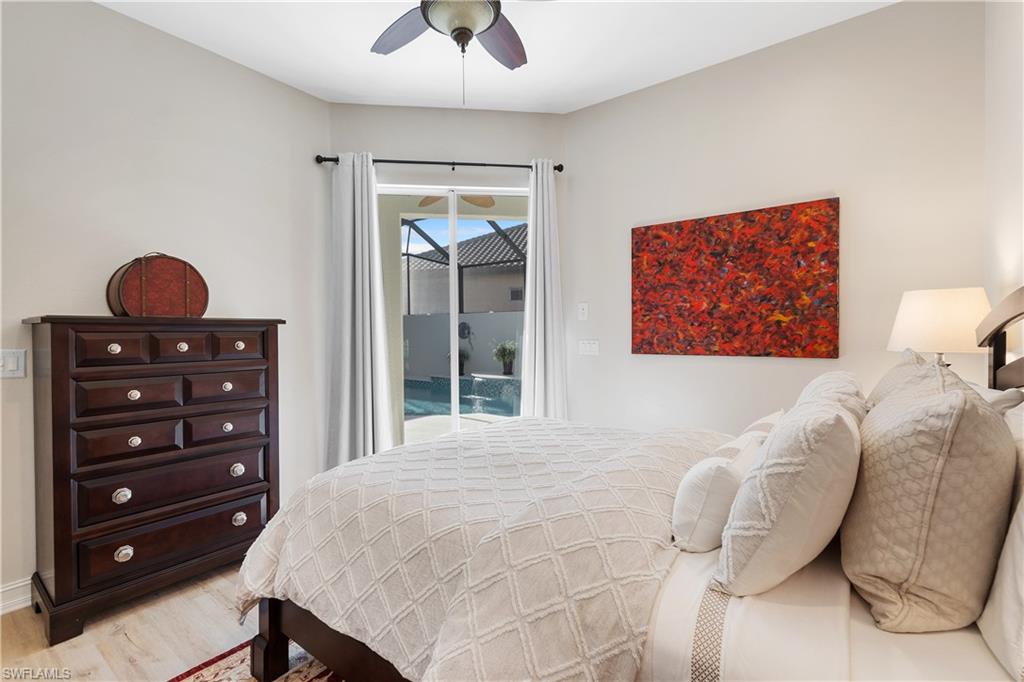 12612 Grandezza Circle Estero, FL 33928 - Photo 33 of 48 Bedroom with ceiling fan, access to outside, and light hardwood / wood-style floors