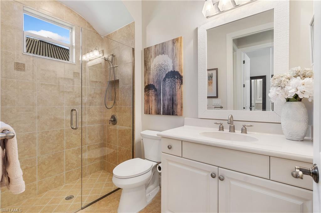 12612 Grandezza Circle Estero, FL 33928 - Photo 34 of 48 Bathroom featuring an enclosed shower, vanity, and toilet