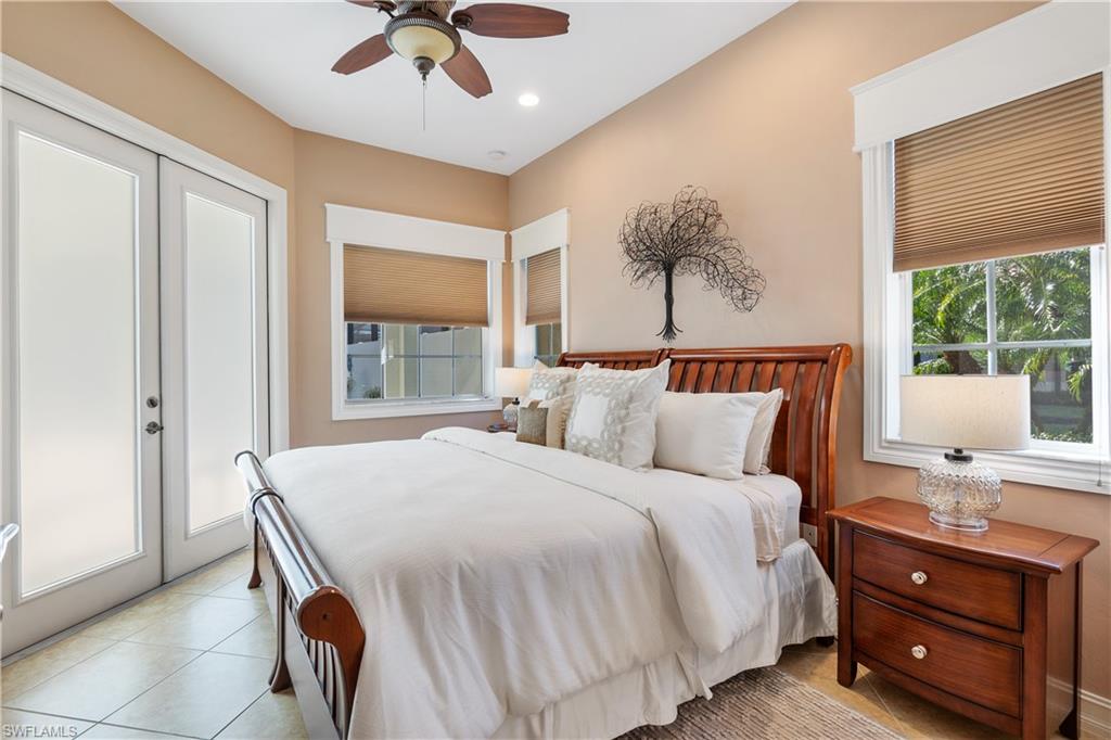 12612 Grandezza Circle Estero, FL 33928 - Photo 35 of 48 Tiled bedroom featuring access to outside and ceiling fan