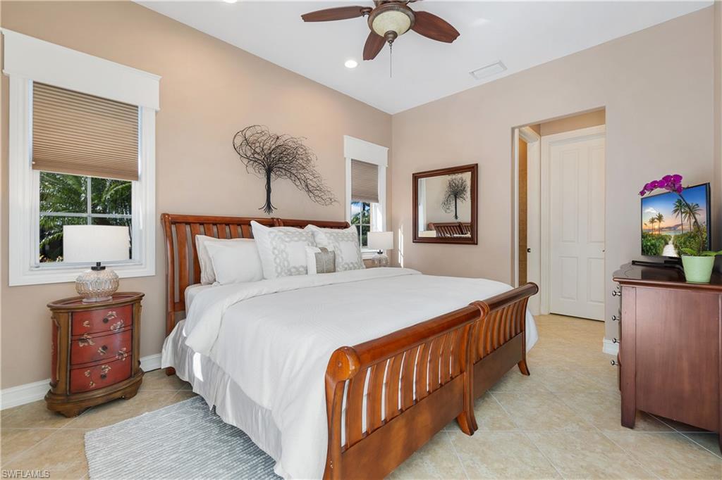 12612 Grandezza Circle Estero, FL 33928 - Photo 36 of 48 Tiled bedroom with ceiling fan