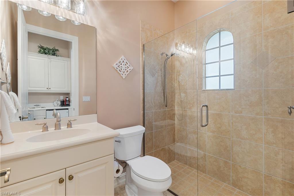 12612 Grandezza Circle Estero, FL 33928 - Photo 38 of 48 Bathroom with vanity, toilet, and an enclosed shower