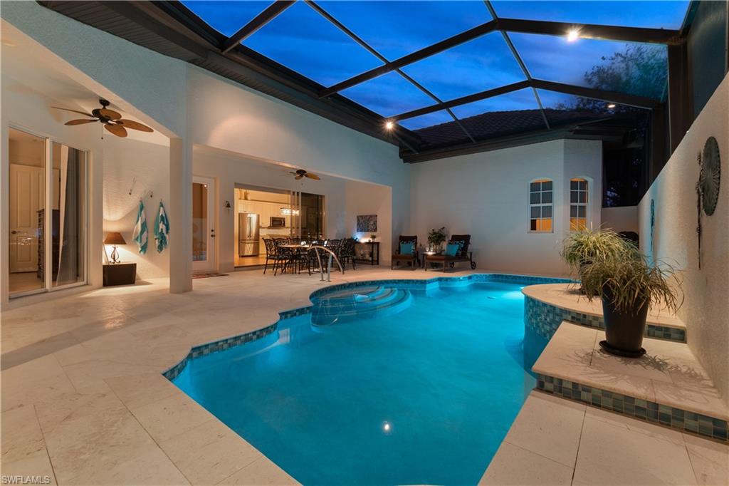 12612 Grandezza Circle Estero, FL 33928 - Photo 44 of 48 Pool at dusk with ceiling fan, a lanai, and a patio