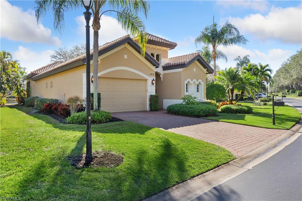 12612 Grandezza Circle Estero, FL 33928 - Photo 5 of 48 Mediterranean / spanish-style house featuring a garage and a front yard