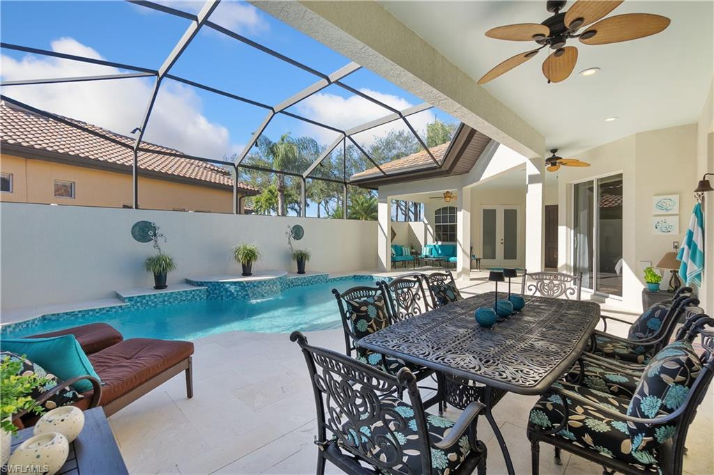 12612 Grandezza Circle Estero, FL 33928 - Photo 8 of 48 View of pool with a patio area, pool water feature, ceiling fan, and glass enclosure