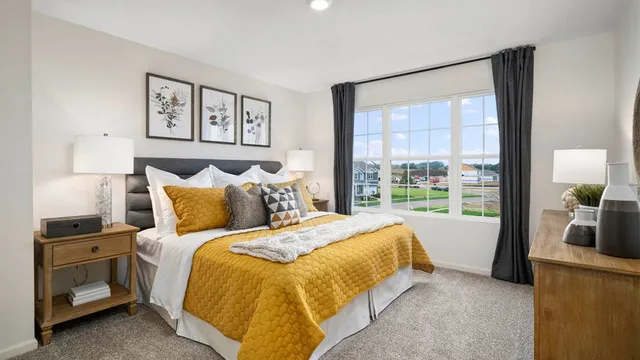 a bedroom with a bed and a large window