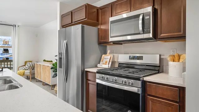 a kitchen with stainless steel appliances a stove a microwave and a refrigerator