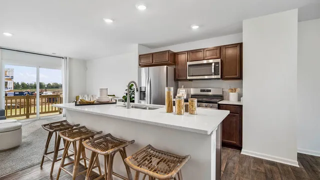 a kitchen with stainless steel appliances a microwave a stove and refrigerator