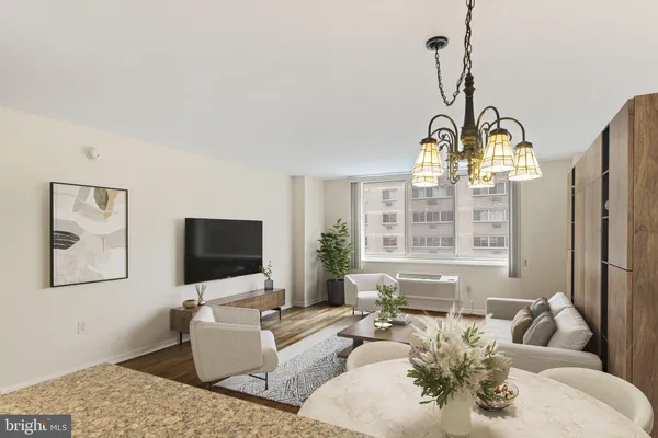 a living room with furniture a large window and a flat screen tv