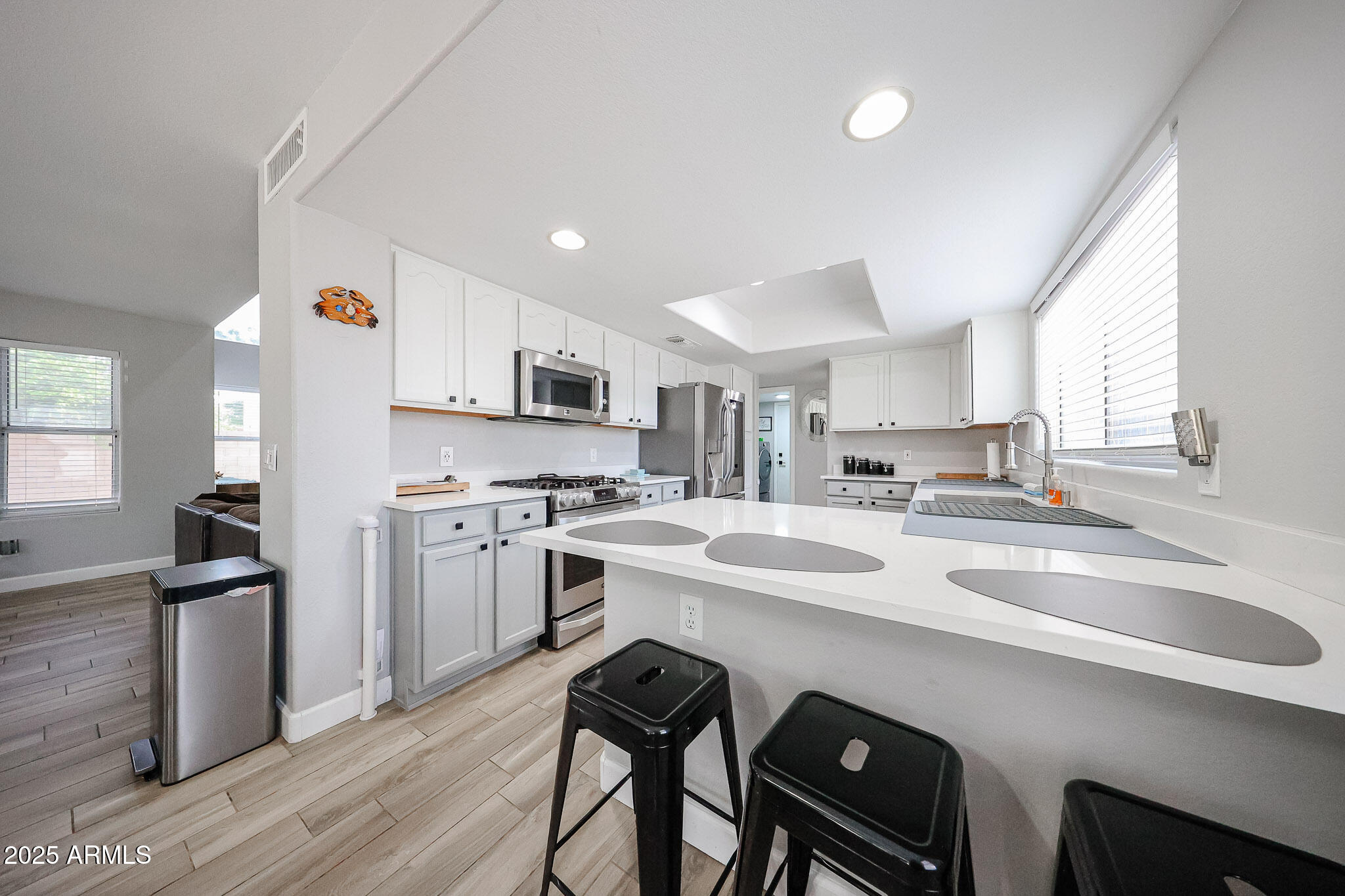 3902 East Rosemonte Drive Phoenix, AZ 85050 - Photo 13 of 46 a kitchen that has a sink a stove and chairs