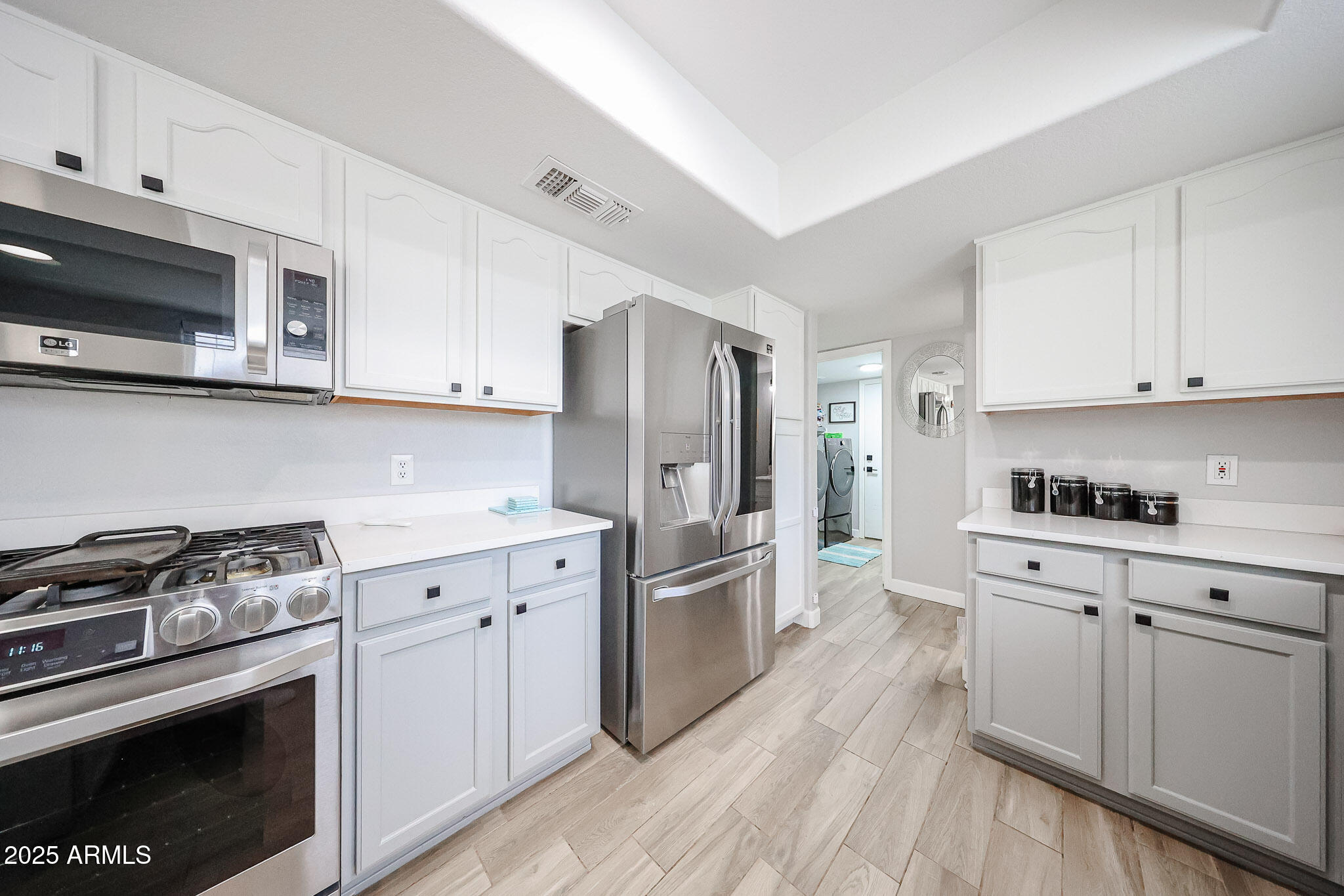 3902 East Rosemonte Drive Phoenix, AZ 85050 - Photo 15 of 46 a kitchen with stainless steel appliances a stove a sink and a refrigerator