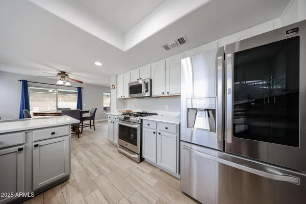 a kitchen with a refrigerator stove and microwave