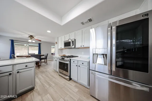 a kitchen with a refrigerator stove and microwave