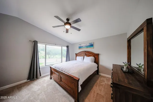 a bed room with a bed window and a flat tv screen