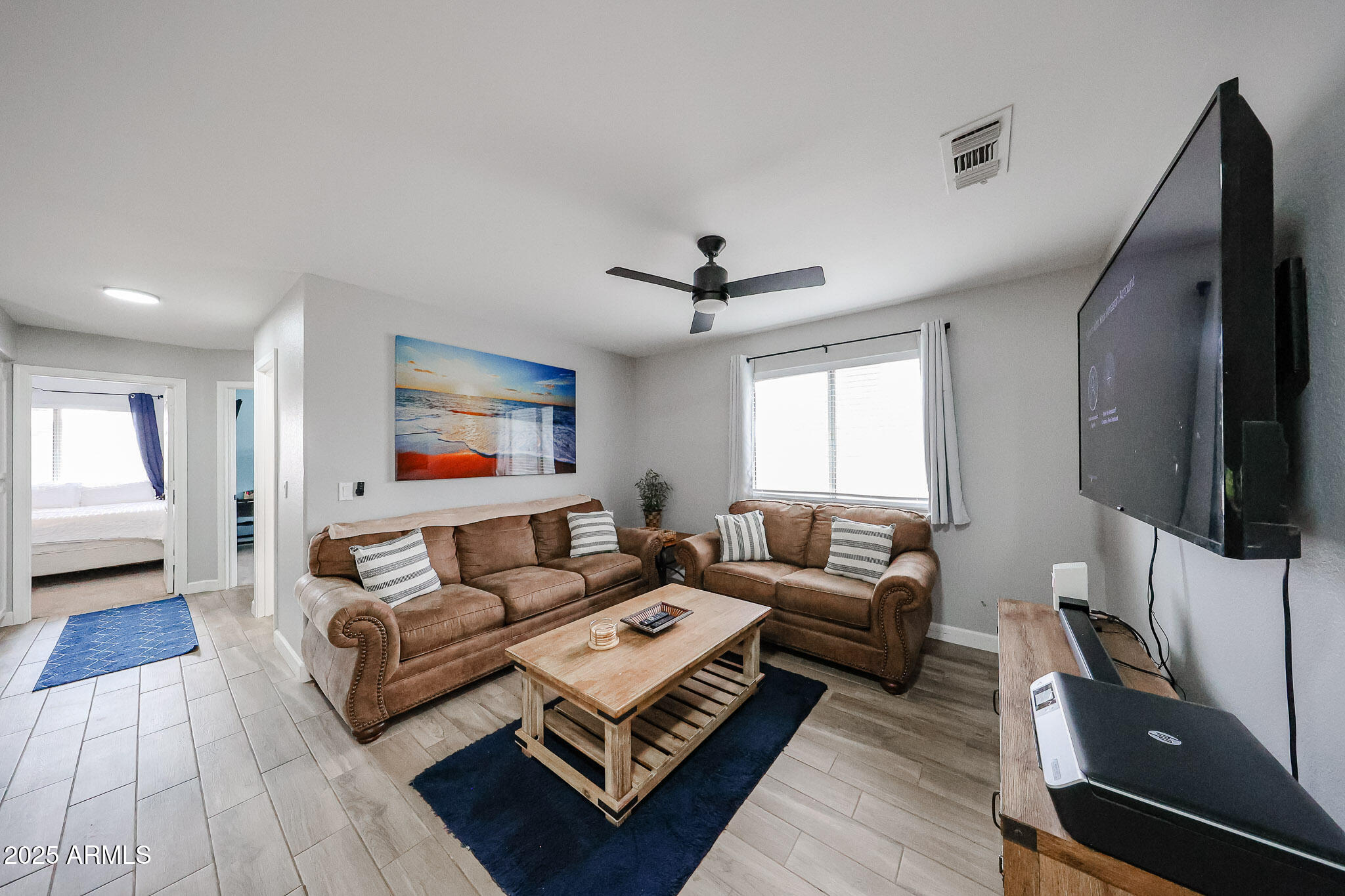 3902 East Rosemonte Drive Phoenix, AZ 85050 - Photo 25 of 46 a living room with furniture and a flat screen tv