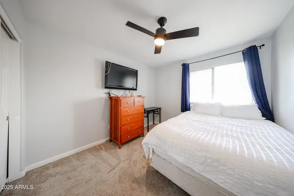 a bedroom with a bed and a flat screen tv