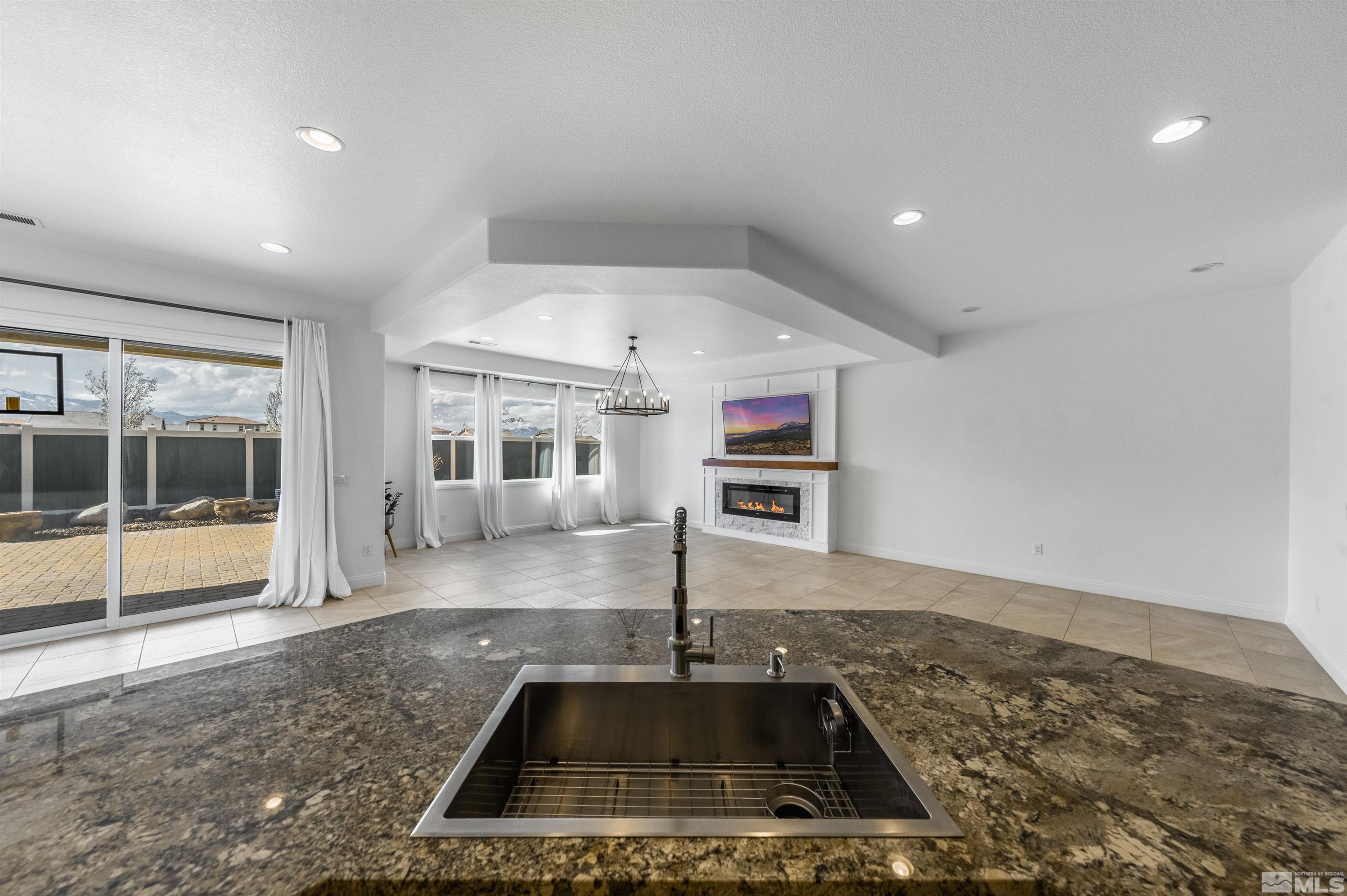10065 Ellis Park Lane Reno, NV 89521 - Photo 12 of 30 a kitchen with a sink a counter top space cabinets and stainless steel appliances